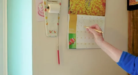 Close Up of Elderly Hand Crossing Out Date on Calendar Stock Footage 332254060