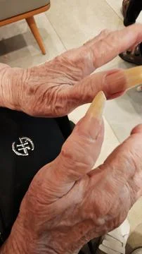 Close-Up of Elderly Hands with Long Natural Fingernails–Aging &amp; Senior Care Stock Photos