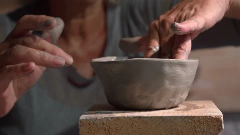 Close-up of elderly hands sculpting clay in pottery workshop Stock Footage 318570040