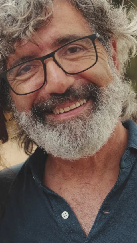 Close-up of an elderly man crossing his arms and looking at the camera with Stock Footage 252503987