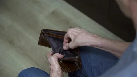 Close-up of elderly man examining empty wallet Stock Footage 307402676