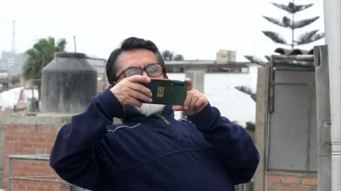 Close-up of an elderly man with glasses and a beard and white mustache taking a Stock Footage 160088976