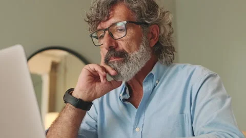 Close up, elderly man with glasses in living-room using laptop computer Stock Footage 254913355