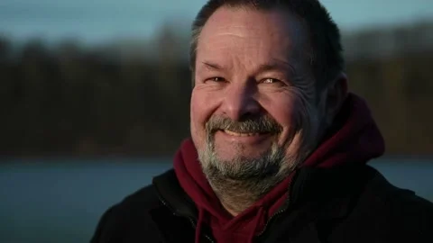Close-up of an elderly man with a gray beard and wrinkles, laughing Stock Footage 170195067