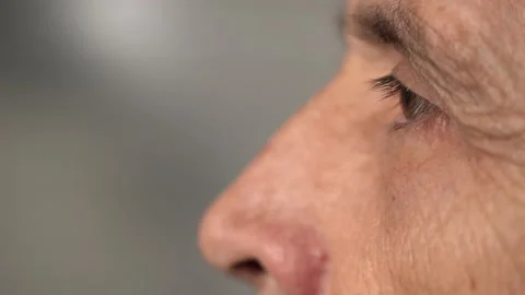 Close-up of an elderly man looking one way against a blurred background Stock Footage 145196115