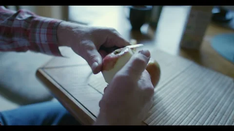 Close Up of Elderly Man Peeling a Harvested Apple from the Garden Stock Footage 344770003