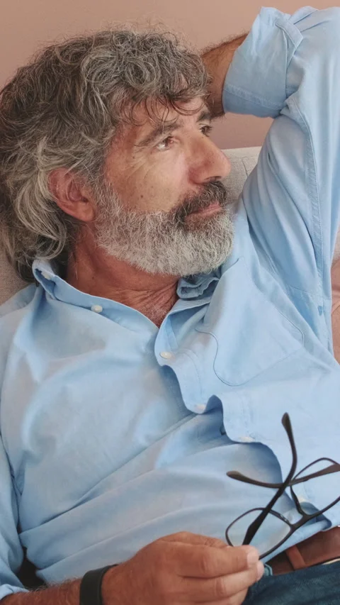 Close up, an elderly man is resting lying on the sofa in cozy living-room Stock Footage 252207349