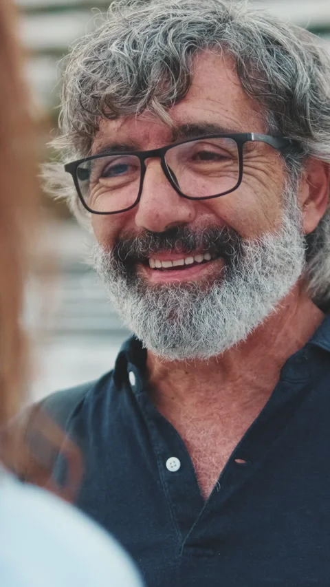 Close-up of an elderly man standing in the port and talking to his girlfriend on Video stock 252504026