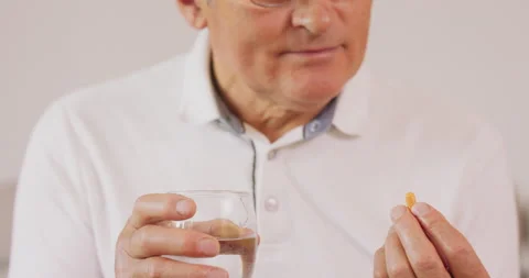 A close-up of an elderly man taking his medication. Stock Footage 144928665