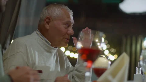 Close-up of Elderly Man Talking at the Restaurant Table During Dinner Stock Footage 280391372
