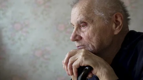 Close-up of Elderly Man with Walking Stick, Contemplative Gaze Stock Footage 306084942