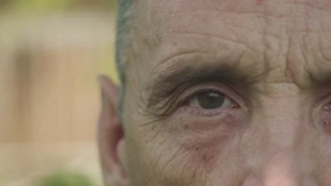 Close-up of elderly man's eye looking in camera Stock Footage 156950376
