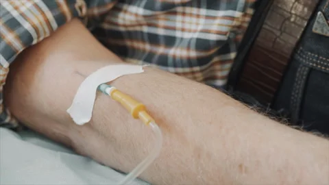 Close-up of an elderly mans hand with an IV needle in his arm. Stock Footage 302175953
