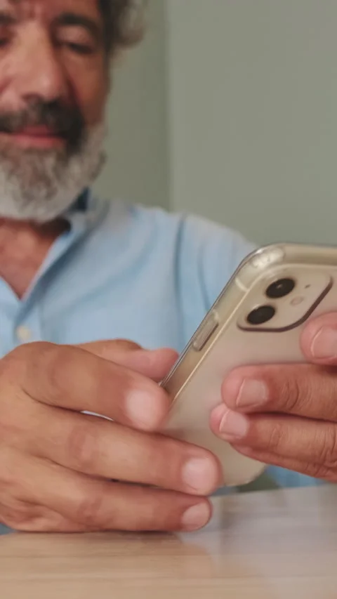 Close-up of an elderly man's hands sending text messages from mobile phone, Stock Footage 252207293