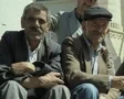 Close up of elderly men sitting outside mosque SD Footage