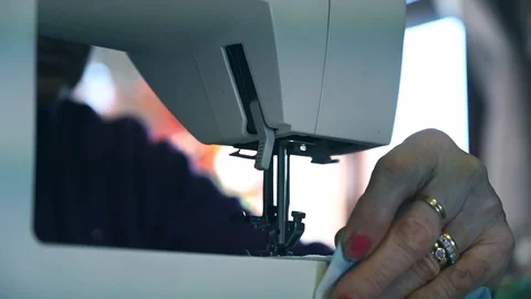 Close up of elderly old woman using sewing machine Stock Footage 103409797