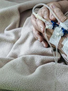 Close-up of Elderly Patient's Hands with IV Drip in Hospital Bed Stock Photos
