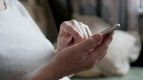 Close Up Of Elderly Person Using A Smartphone Communicating In Messenger Or Apps Video stock 145482299