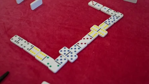 Close-up of elderly players placing domino tiles during a game, highlighting Stock Footage 337712825