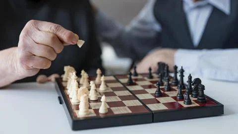 Close up elderly playing chess Stock Photos