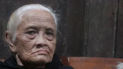 Close up of an elderly woman from Java Indonesia chewing betel. Stock Footage 296359442