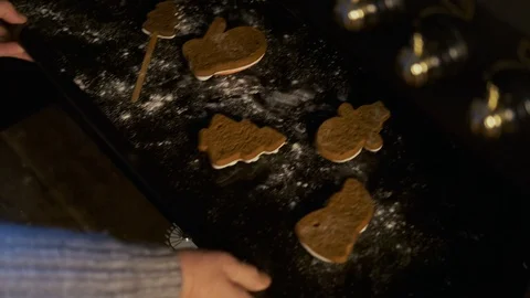 Close-up of an elderly woman pulls out Christmas cookies from the oven Stock Footage 122225989