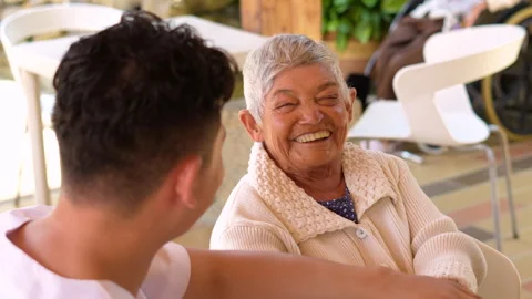 Close-up of an elderly woman smiling warmly and waving. Stock Footage 285421884