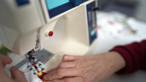 Close-up of an elderly woman's hand adjusting the sewing machine. Stay at home Stock Footage 148344569