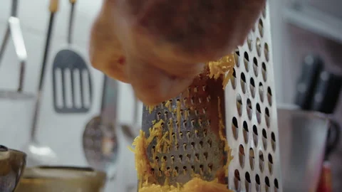 Close-up, elderly womans hand grating pumpkin to make pumpkin cake Stock Footage 318853099