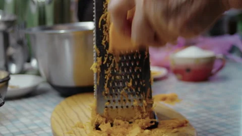 Close-up, elderly woman's hand grating pumpkin on pie grater Stock Footage 337118911