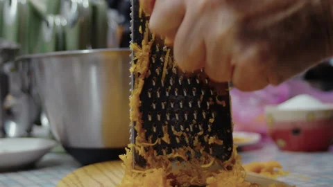 Close-up, elderly woman's hand grating pumpkin for pie making Stock Footage 337120923