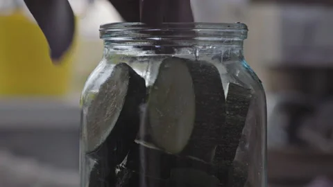Close-up, Elderly Woman's Hand Puts In Jar Sliced Zucchini for Marinade Making Stock Footage 158374987