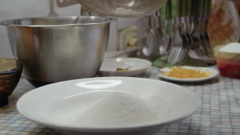 Close-up, elderly woman's hand sifting flour through sieve on kitchen table Stock Footage 337120217