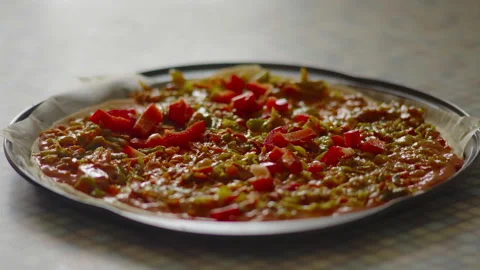 Close-up, an elderly woman's hand sprinkles slices of sliced pepper on pizza Stock Footage 176460648