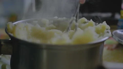 Close-up, Elderly Woman's Hand Tolch Freshly Cooked Potato Puree in Metal Bar Stock Footage 150134794