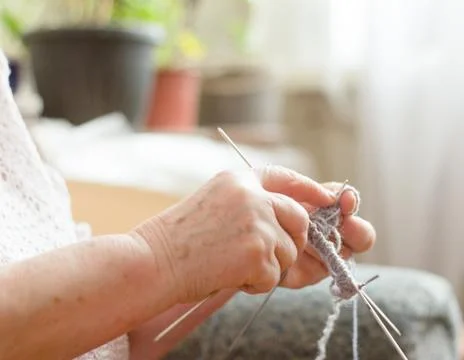 Close up of an elderly woman's hands knitting socks Stock Photos