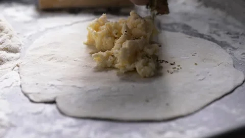 Close-up of an elderly woman's hands preparing cheese-filled panzerotto in .. Stock-Footage 291367851
