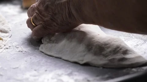 Close-up of an elderly woman's hands preparing cheese-filled panzerotto in .. 動画素材 291367862
