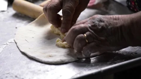 Close-up of an elderly woman's hands preparing cheese-filled panzerotto in .. 動画素材 291367889
