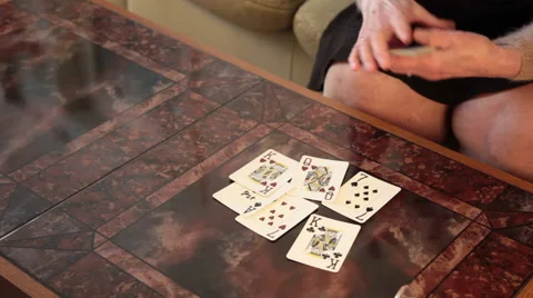 Close up on an elderly woman's hands shuffling playing cards on the table Stock Footage 62773567