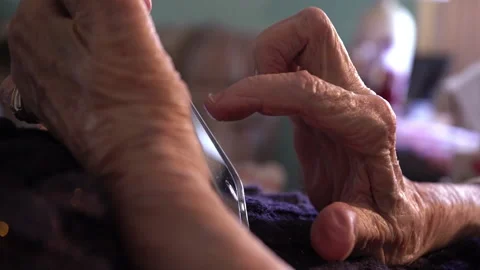 Close up of an elderly woman's hands while using a smart phone Stock Footage 237001244