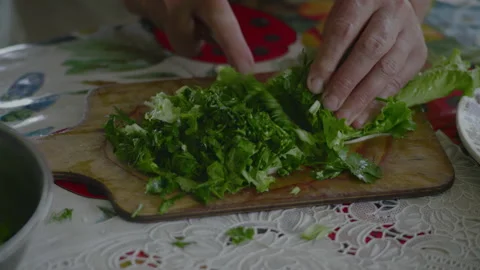 Close-up, Elderly Women's Hands Cut Fresh Salad on Wooden Board Stock Footage 147001526