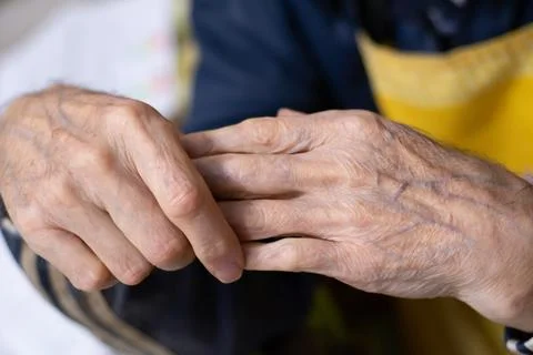 Close up of elderly wrinkled hands, aging skin detail. senior healthcare co.. Stock Photos