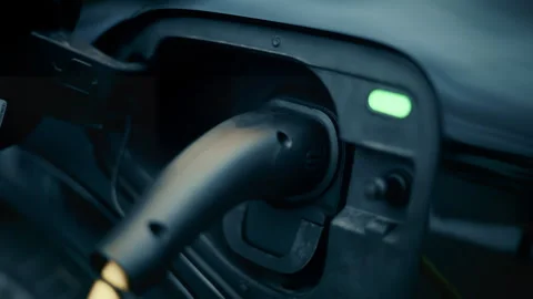 Close up of an electric car being charged, with cable plugged into port Stock Footage 320643667
