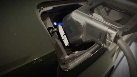 Close-up of electric car charging cable plugged into EV port Stock Footage 346512432