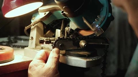 Close up of Electric Chain Sharpening For Chainsaws In Lamp Light by Male Video stock 131313551