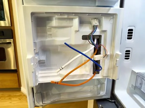 Close up of electric component panel board and reservoir in home refrigerator Stock Photos