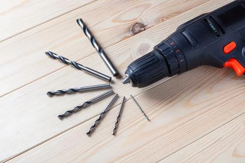 Close up Electric drill, Drill set, Screwdriver set on wooden table backgro.. Stock Photos
