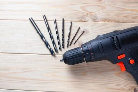 Close up Electric drill, Drill set, Screwdriver set on wooden table backgro.. Stock Photos