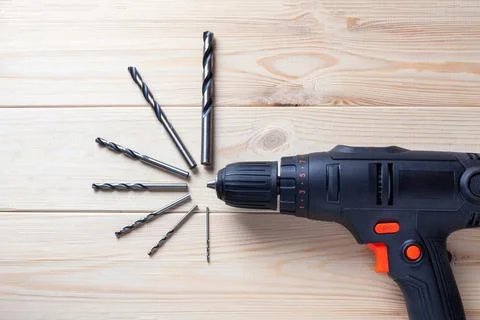 Close up Electric drill, Drill set, Screwdriver set on wooden table background Stock Photos
